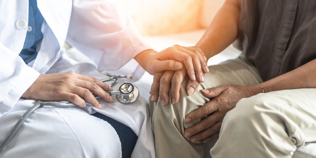 doctor holding patients hand